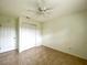 A bedroom with a ceiling fan, closet, and tile flooring at 3523 Colleen Dr, Lakeland, FL 33810