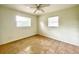 Bright bedroom features tile floors, a ceiling fan, and two windows at 3523 Colleen Dr, Lakeland, FL 33810