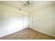 Bright bedroom featuring tile floors, a ceiling fan, and two windows at 3523 Colleen Dr, Lakeland, FL 33810