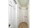 Hallway featuring neutral walls, tile floors, and multiple white doors at 3523 Colleen Dr, Lakeland, FL 33810