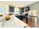 Modern kitchen with stainless steel appliances and bright white marble countertops at 3523 Colleen Dr, Lakeland, FL 33810