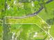 Aerial view of acreage featuring lush greenery, mature trees, and partially cleared areas ready for development at 1096 Drew St, Lakeland, FL 33810