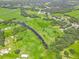 Panoramic view of a vast property showcasing natural streams, lush green spaces, and proximity to a residential area at 1096 Drew St, Lakeland, FL 33810