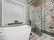 Modern bathroom featuring a stylish soaking tub and a walk-in shower with patterned tiles at 1096 Drew St, Lakeland, FL 33810