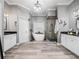 Elegant bathroom featuring a modern soaking tub, a glass-enclosed shower, and dual vanities at 1096 Drew St, Lakeland, FL 33810