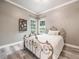 Cozy bedroom with an iron bed frame, a view of the outdoors, and hardwood floors at 1096 Drew St, Lakeland, FL 33810