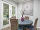 Cozy breakfast nook with a round table, wicker chairs, and glass doors leading to the pool area at 1096 Drew St, Lakeland, FL 33810
