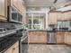 Well-appointed kitchen with stainless steel appliances, dark countertops, and a view of the screened patio at 1096 Drew St, Lakeland, FL 33810