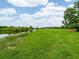 Aerial view of land featuring lush grass leading to water with scattered trees and a bright sky at 1096 Drew St, Lakeland, FL 33810