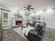 Cozy living room featuring a brick fireplace, plush sofa, and ample natural light from large windows at 1096 Drew St, Lakeland, FL 33810