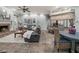 Open-concept living room with a fireplace, comfortable seating, and adjacent kitchen with breakfast bar at 1096 Drew St, Lakeland, FL 33810
