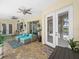 Covered patio boasts comfortable seating, ceiling fans and brick pavers overlooking the pool at 1096 Drew St, Lakeland, FL 33810