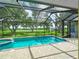 Relax by the screened pool with views of the green pastures and beautiful surrounding trees at 1096 Drew St, Lakeland, FL 33810