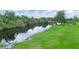 Scenic aerial view of a waterfront area with lush greenery and trees under a partly cloudy sky at 1096 Drew St, Lakeland, FL 33810