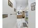 Hallway view into primary bathroom with vanity and glass enclosed walk-in shower at 1323 Hammock Shade Dr, Lakeland, FL 33809