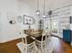 Farmhouse-style dining room with a rustic wood table, white chairs, and shiplap accent wall at 1323 Hammock Shade Dr, Lakeland, FL 33809