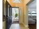 Inviting entryway with a decorative glass front door and view into the living room at 1323 Hammock Shade Dr, Lakeland, FL 33809