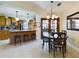Open-concept kitchen and dining area with a breakfast bar and modern finishes at 1323 Hammock Shade Dr, Lakeland, FL 33809