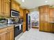 Traditional kitchen with stainless steel appliances, granite countertops, and light wood cabinets at 1323 Hammock Shade Dr, Lakeland, FL 33809