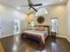 Open main bedroom with hardwood floors, ceiling fan, and ensuite bathroom with glass door at 1323 Hammock Shade Dr, Lakeland, FL 33809