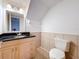 Bathroom with black granite countertop and light wood cabinets at 1426 Persimmon Way, Lakeland, FL 33811