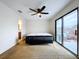 Bright bedroom with sliding glass doors, carpet, and ceiling fan at 1426 Persimmon Way, Lakeland, FL 33811
