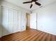 Bedroom with wood flooring, double door closet and ceiling fan at 1426 Persimmon Way, Lakeland, FL 33811