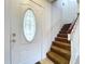 Front entry with a white door, glass accents and a staircase at 1426 Persimmon Way, Lakeland, FL 33811