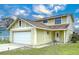 Two-story house with a large window and a neatly landscaped yard at 1426 Persimmon Way, Lakeland, FL 33811
