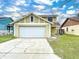 Two-story house with a white garage door and well-maintained lawn at 1426 Persimmon Way, Lakeland, FL 33811