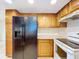 Modern kitchen with black refrigerator and white appliances at 1426 Persimmon Way, Lakeland, FL 33811