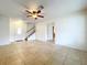 Living room with tile flooring, staircase and ceiling fan at 1426 Persimmon Way, Lakeland, FL 33811