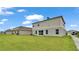Spacious backyard with lawn and neighboring homes at 5528 Arlington River Dr, Lakeland, FL 33811