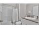 Clean bathroom with shower/tub combo, granite countertop vanity, and white cabinets at 5528 Arlington River Dr, Lakeland, FL 33811