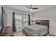 Comfortable bedroom with a double bed, a TV, and large windows at 5528 Arlington River Dr, Lakeland, FL 33811