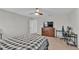 Bedroom with a bed, dresser, and desk, offering great natural light at 5528 Arlington River Dr, Lakeland, FL 33811