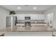Modern kitchen with white cabinets, granite countertops, and stainless steel appliances at 5528 Arlington River Dr, Lakeland, FL 33811