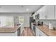 Modern kitchen with white cabinets, granite countertops, and stainless steel appliances at 5528 Arlington River Dr, Lakeland, FL 33811