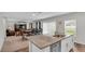 Open concept kitchen with island, granite countertops, and view of the dining area at 5528 Arlington River Dr, Lakeland, FL 33811