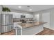 Modern kitchen with white cabinets, granite countertops, and stainless steel appliances at 5528 Arlington River Dr, Lakeland, FL 33811