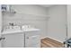 Bright laundry room with washer, dryer, and shelving at 5528 Arlington River Dr, Lakeland, FL 33811