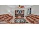 Relaxing living room with brown leather sofas and a built-in entertainment center at 5528 Arlington River Dr, Lakeland, FL 33811
