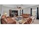 Spacious living room featuring brown leather sofas, a media console, and a fireplace at 5528 Arlington River Dr, Lakeland, FL 33811