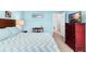 Main bedroom with a dresser, tv, and comfortable bedding at 1920 E Edgewood Dr # G5, Lakeland, FL 33803