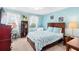 Bedroom with light blue walls, a comfortable bed, and built-in shelving at 1920 E Edgewood Dr # G5, Lakeland, FL 33803