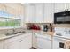Kitchen with granite countertops, white cabinets, and modern appliances at 1920 E Edgewood Dr # G5, Lakeland, FL 33803