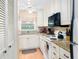 Well-equipped kitchen with granite countertops and white cabinets at 1920 E Edgewood Dr # G5, Lakeland, FL 33803