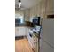 Well-lit kitchen with white cabinets, granite countertops, and modern appliances at 1920 E Edgewood Dr # G5, Lakeland, FL 33803