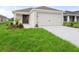Newly constructed home with a one-car garage and well-manicured lawn at 631 Bentley North Dr, Auburndale, FL 33823