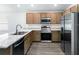 Modern kitchen with stainless steel appliances and light wood cabinets at 631 Bentley North Dr, Auburndale, FL 33823